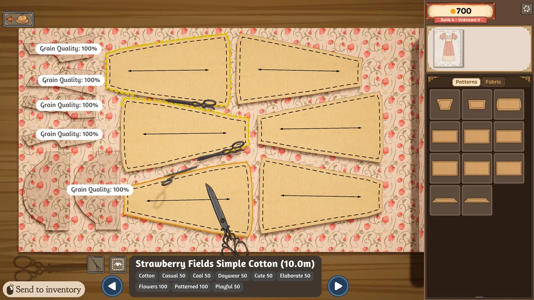 Paper pattern pieces laid out on strawberry-print fabric with shears resting on the cloth